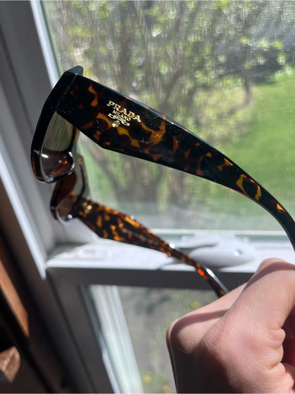 PradaTortoiseshell Sunglasses with Black Lenses